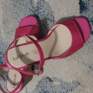A pair of pink Life Stride sandals.